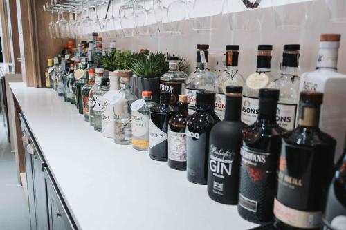 a row of bottles of wine on a counter at Edgbaston Park Hotel Birmingham in Birmingham