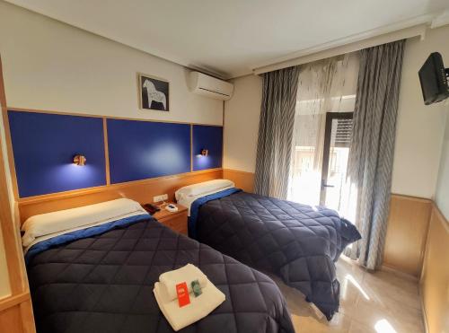Cama o camas de una habitación en Trípolis Toledo