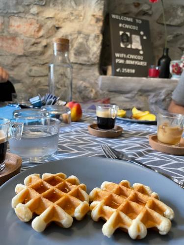 two waffles on a plate on a table at CIVICO 2 in Costa Volpino