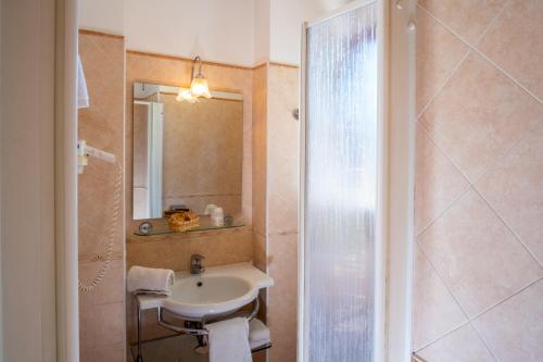 a bathroom with a sink and a shower at Hotel Savoia Sorrento in Sorrento