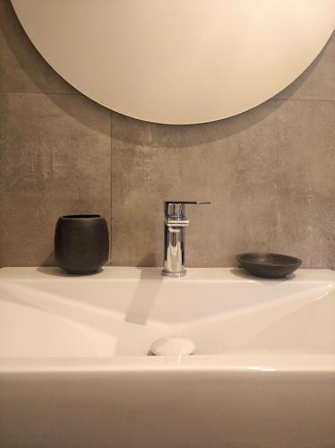 a sink with a soap dispenser and a bowl on it at Il Mulino in Locri