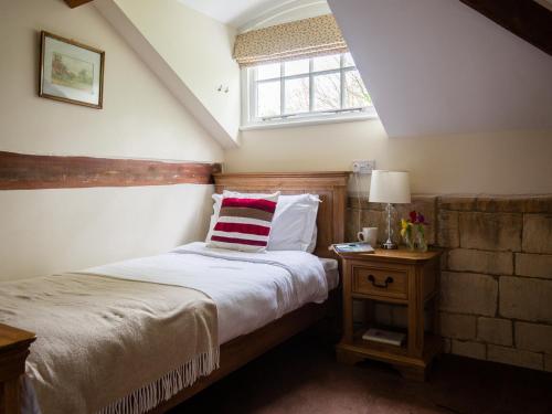 a bedroom with a bed and a window at Prince Rupert in Winchcombe