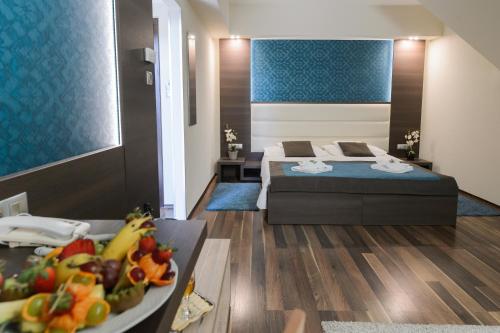 Кровать или кровати в номере Hotel Villa Völgy Wellness & Konferencia