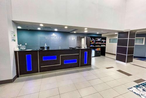 a lobby with a bar with blue lights on it at Wingate by Wyndham Panama City Area Lynn Haven in Panama City