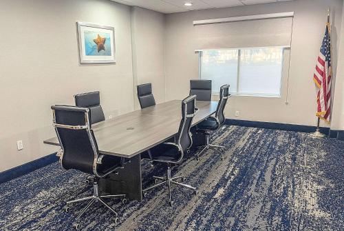a conference room with a wooden table and chairs at Wingate by Wyndham Panama City Area Lynn Haven in Panama City