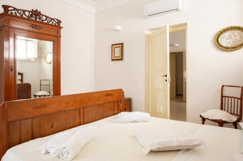 a bedroom with a bed and a large mirror at A Vanedda in Noto