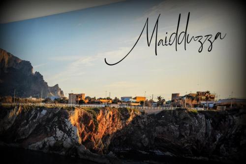 a sign that reads mulusalem on top of a mountain at PESCA AZZURRA in Terrasini