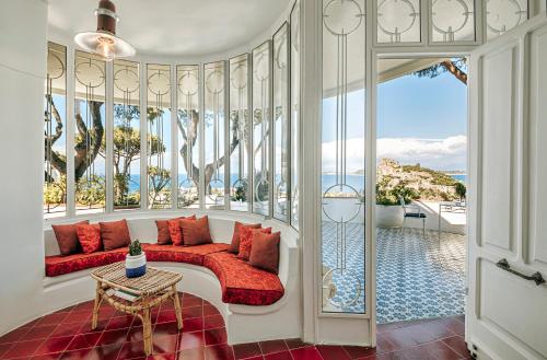 a living room with a couch and a view of the ocean at Villa Livia in Ischia