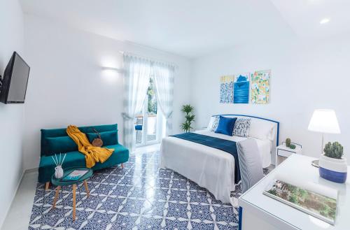 a bedroom with a bed and a couch at Villa Livia in Ischia