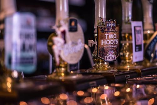 a bar with two bottles of alcohol on a table at Old Hall Hotel Hope in Hope