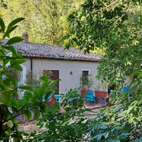 a house with two blue chairs in front of it at Chiosi Country Club in Corleone