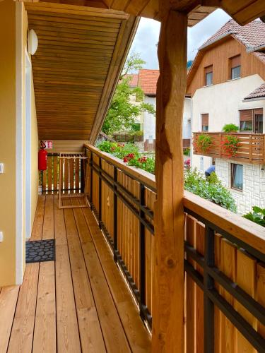 a wooden deck with a view of a building at BeeWood apartment in Križe