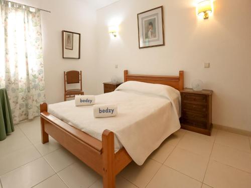 a bedroom with a bed with two pillows on it at Praia da Oura Apartment - 100 m from the Beach - By Bedzy in Albufeira