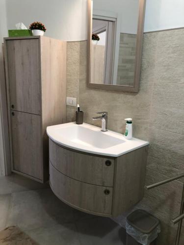 a bathroom with a sink and a mirror at Giorgia&Greta- relax casa vacanze in Olbia