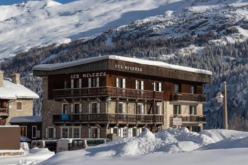 a building in the snow in front of a mountain at CHALET AUBERGE - Les Mélèzes in Tignes