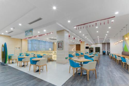 a dining room with blue tables and chairs at Holiday Inn Express Suzhou Changjiang by IHG in Suzhou