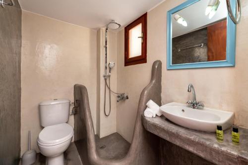 a bathroom with a sink and a toilet and a shower at Marina's Studios in Perivolos