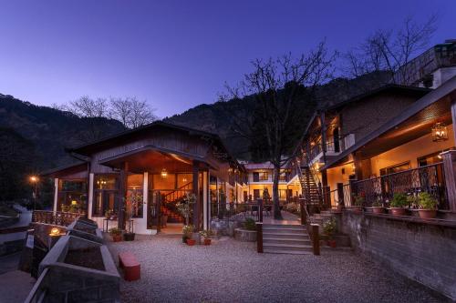 a building with a staircase leading to it at night at The Earls Court by Leisure Hotels in Nainital