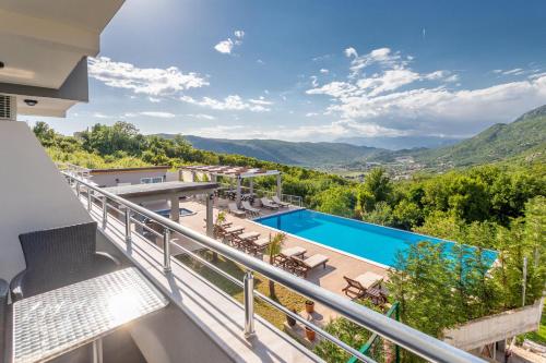 a view from the balcony of a villa with a swimming pool at Resort Bevilacqua in Budva