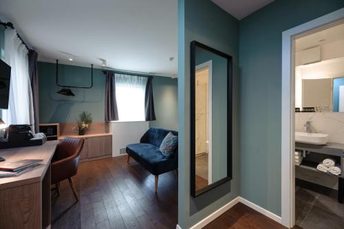 a living room with a mirror and a blue wall at Camera Hotel in Split