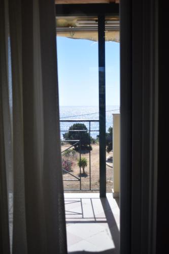a view of the ocean from a window at Sea & Sky by Marisa in Petrokhorion