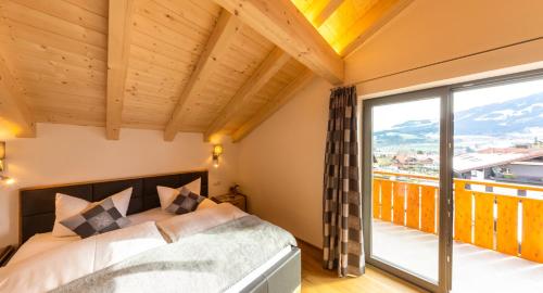 1 dormitorio con cama y ventana grande en Haus Allgäublick, en Fischen