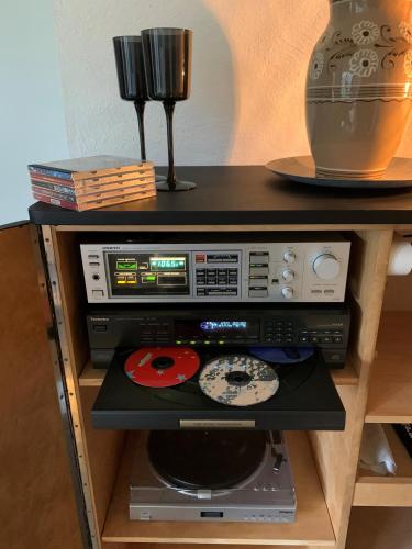 a shelf with a cd and other electronics on it at Skogshöjda in Tjörnarp