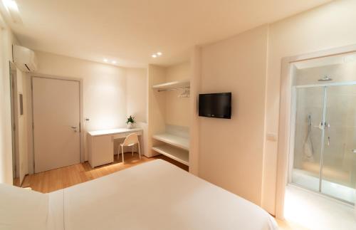 a bedroom with a bed and a tv on a wall at Hotel Country House La Radice in Civitanova Marche