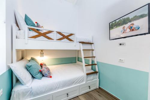 a bunk bed in a room with a tv at Suite Christina in Symi