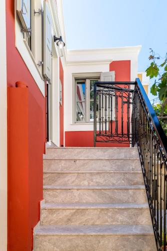 a staircase in a building with red and white walls at Suite Christina in Symi