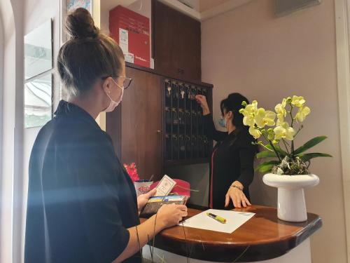 two women standing at a table in a coffee shop at Villa Mirella-NUOVA GESTIONE in Grado