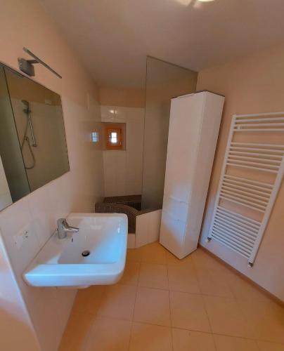 a bathroom with a white sink and a mirror at L'angolo di Giulia in Castelletto di Brenzone