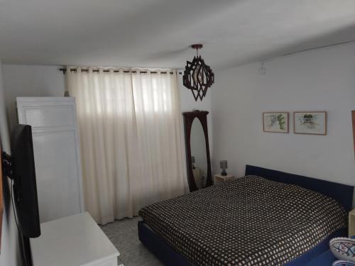 Schlafzimmer mit einem Bett, einem Spiegel und einem Kronleuchter in der Unterkunft Suite à sidi bou Saïd in Sidi Bou Saïd