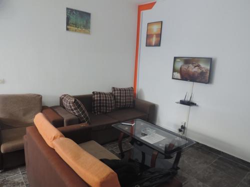 a living room with a couch and a table at Happy Welcome Bietry in Abidjan