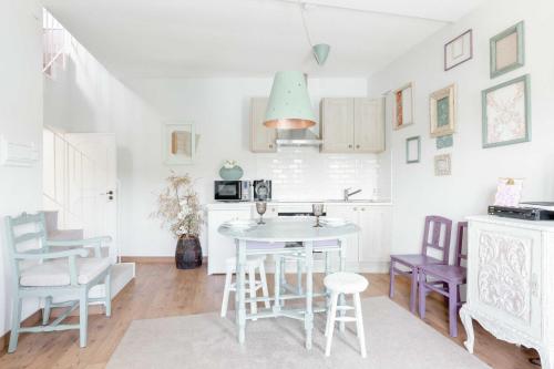 a kitchen and dining room with a table and chairs at Quinta da Agraceira Casa do Caseiro in Vila Nova de Gaia