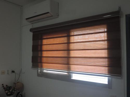 a window with wooden blinds in a room at Happy Welcome Bietry in Abidjan
