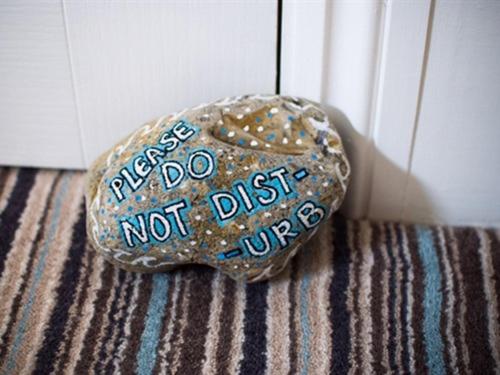 a rock with writing on it sitting on a floor at The Wayfarer Rooms in Bexhill