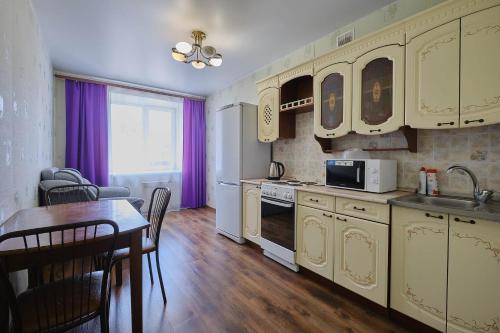 a kitchen with a table and a dining room at ОК! Советская, 69 №5 in Tomsk