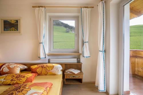 Habitación con cama y ventana en Ferienwohnung Kirchblick Gasser, en Terento
