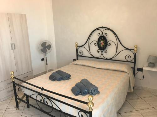 a bedroom with a bed with two pillows on it at Casa Vacanza Chiara in Tropea