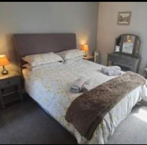 a bedroom with a large bed with two shoes on it at The Royal George Staithes in Staithes