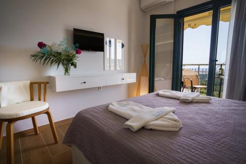 a room with a bed with two towels on it at Eleni Studios Parga in Parga
