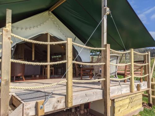 a large green tent with ropes around it at Hakuna Matata Safari Lodge - Sublime, off-grid digital detox with hot tub in Shelsley Walsh