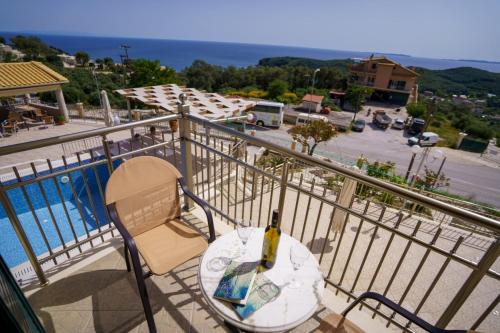 a bottle of wine sitting on a table on a balcony at Eleni Studios Parga in Parga