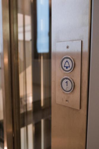 an elevator door with two signs on it at B&B Palazzo Storico Di Nicola in Pescara