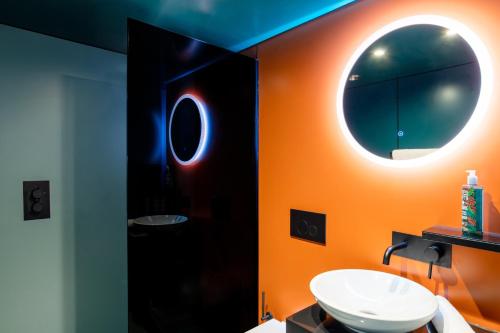 a bathroom with a sink and a mirror at YOTEL Manchester Deansgate in Manchester