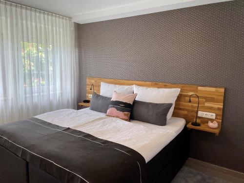 a bedroom with a large bed with two pillows at Appartementanlage Lancken-Granitz in Lancken-Granitz
