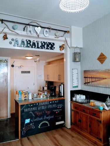 an entrance to a kitchen with a counter in a room at aabAlree Guest House in Dundee