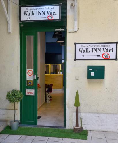 a walkin inn vest sign on the side of a building at Walk Inn Váci 78 in Budapest