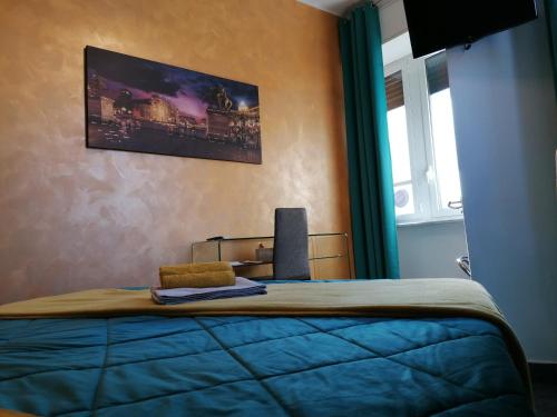 a bedroom with a bed with a tv on the wall at B&B IL SOGNO in Turin